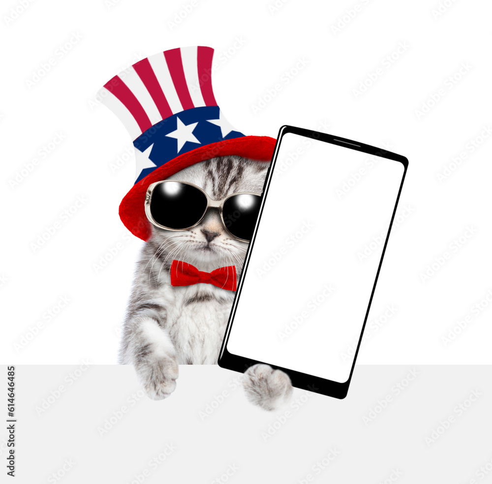 Poster cute kitten wearing like uncle sam showing big smartphone with white blank screen above empty white 