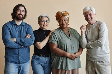 Diverse group of adult people posing together and smiling at camera