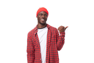 smart confident young american man in red cap and plaid shirt uses hands to gesticulate in...
