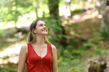 Woman contemplating views walking in a forest
