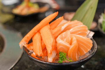 Fresh Japanese Sashimi set in Asian restaurant, orange Salmon and tuna sashimi fish on dish with ice. Japan food concept