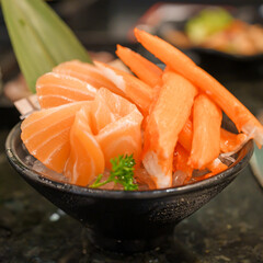 Fresh Japanese Sashimi set in Asian restaurant, orange Salmon and tuna sashimi fish on dish with ice. Japan food concept