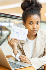 Happy smiling African woman showing English vocab flash card, education concept of english language...