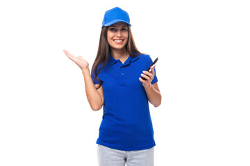 young caucasian brunette advertiser woman in blank blue t-shirt and cap with phone