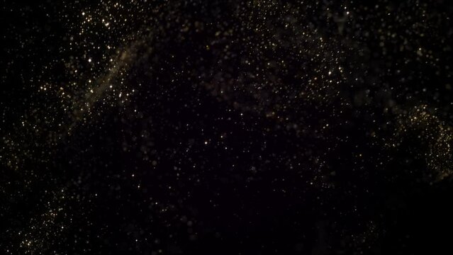Goldem particles moving in slowm otion on black background 4k footage, Gold litters footage, particles moving footage