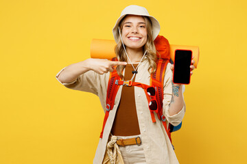 Young woman carry backpack with stuff mat show black screen mobile cell phone isolated on plain...