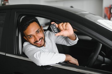 Closeup portrait happy, smiling, young man, buyer showing keys of his new car