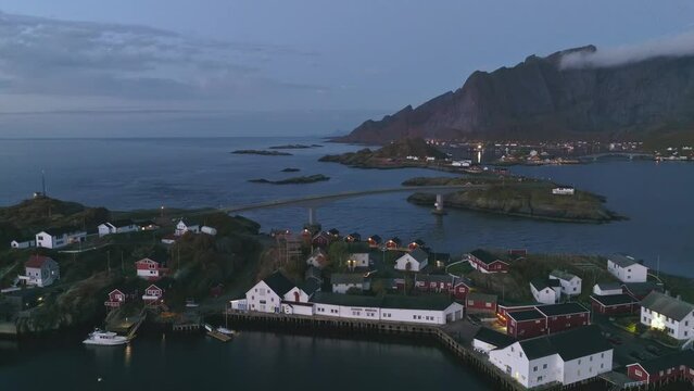 A slow cinematic flight over Hamnoy Norway in the Lofoten islands during Blue Hour