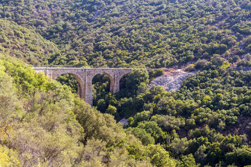 Fototapeta na wymiar View of the railway bridge in the mountains