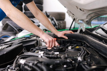 Fototapeta na wymiar Auto mechanic working in garage. Human hands hold tools. Repair service concept