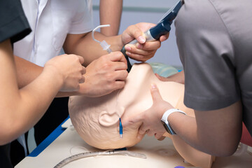 Anesthesiologist performing an orotracheal intubation on a simulation.
mannequin dummy during medical training to control of the airway,Medical manipulation.
