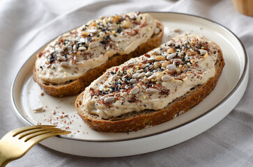 Hummus Toast with Rustic Bread, Vegetarian Snack or Breakfast on Bright Background