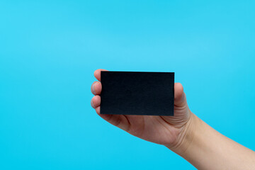 People hand holding a business card