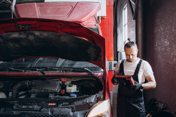 Professional bus mechanic working in vehicle repair service