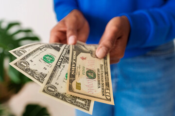 Close-up of woman holding paper currency
