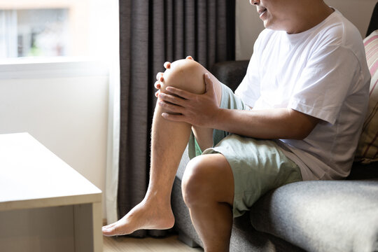 Asian middle aged man suffer from Arthritis,Patellar Tendinitis,symptom of Gout,deposition of chalkstones,painful inflammation and stiffness of the joints,ligament injuries,feel tingling pain in knee