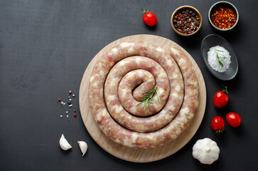 Traditional Raw Spiral Sausages, Meat Round Sausages on Dark Background