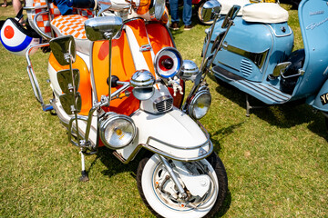The front end of a classic Lambretta scooter on display at a scooter rally on the green in the seaside town of Hunstanton on the North Norfolk coast