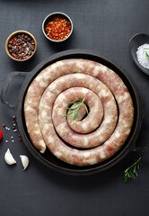 Traditional Raw Spiral Sausages, Meat Round Sausages on Dark Background