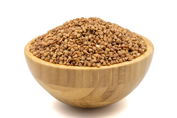 Buckwheat isolated on white background. Buckwheat grains in wooden bowl