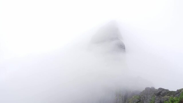Mist flowing over huge mountain Segla in Norway