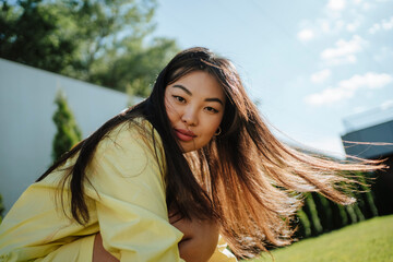 Woman with long hair in backyard
