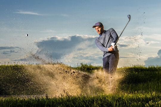 Man playing golf standing on grass