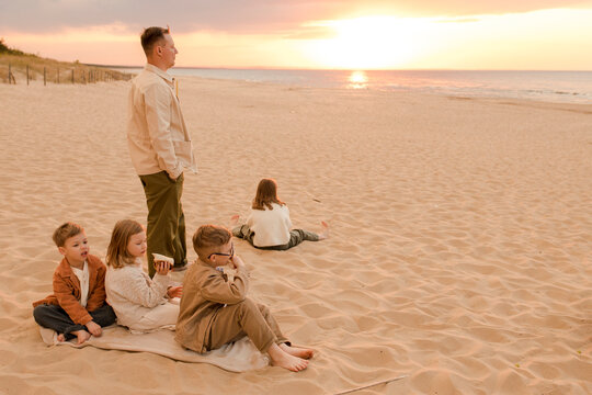Father with children spending time at beach