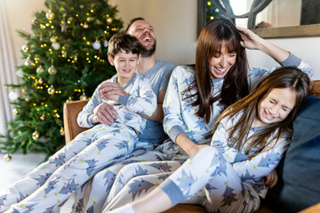 Happy family having fun together at home at Christmas time