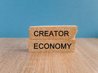 Creator economy symbol. Brick blocks with words Creator economy on beautiful light blue background, copy space. Business and creator economy concept