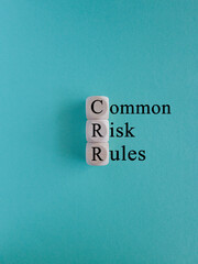 CRR common risk rules symbol. Concept blue words CRR common risk rules on wooden cubes on a beautiful blue background. Business and CRR common risk rules concept. Copy space.