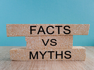 Facts vs myths symbol. Concept words Facts vs myths on brick blocks on a beautiful wooden table...