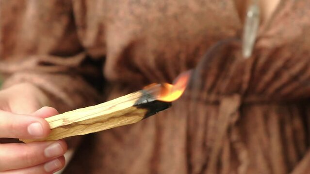 palo santo burning in a woman hand