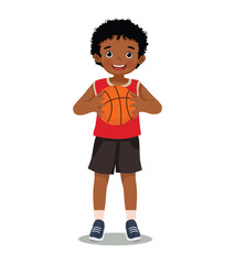 Cute little African boy with sportswear holding basketball with both hands
