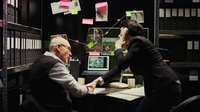 Partners receiving suspect whereabouts, running to catch culprit at secret location. Police officers finding gps coordinates on landline phone call, uncover new case information.