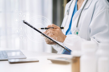 female medical doctor's hands write a note and use tablet working. Doctor's working place. Healthcare and medical concept.