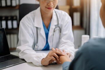 Doctor's hand reassuring elderly patient.