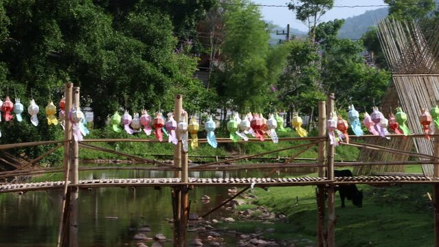 Bamboo footbridge with decorative lanterns in northern Thailand