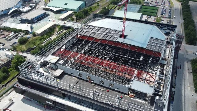 4K Cinematic drone clip moving closer to the construction site of the Co-op Live arena near the Etihad campus in Manchester, UK