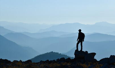 Young Man Watching the Sunrise from the Peak
