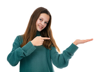 Portrait of twelve year old teenager holding something on her hand and pointing on it, isolated on...