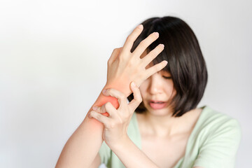 Woman's wrist with inflammation and pain showing red area. Health care concept.