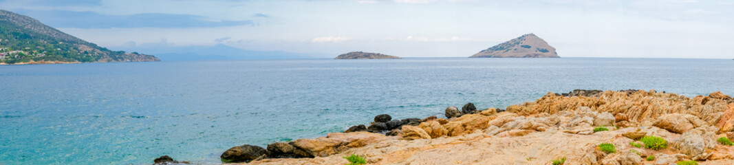 Rocky coast offshore with blue sea, Greece