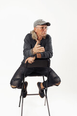 Shot of smiling mature European man dressed in casual grey jumper looks directly at camera being confident in himself