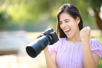 Excited photographer in a park checking results