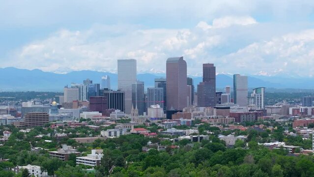 Downtown of Denver, Colorado, USA. Aerial panoramic cityscape with skyscrapers, mountain backdrop.