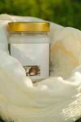 Fresh coconut flakes in a bag with a bottle on grass background 