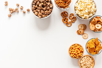 Many bowls of snacks for party - chips popcorn and nuts