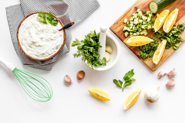 Bowl of dip sauce sour cream with herbs and garlic. Homemade dairy product background