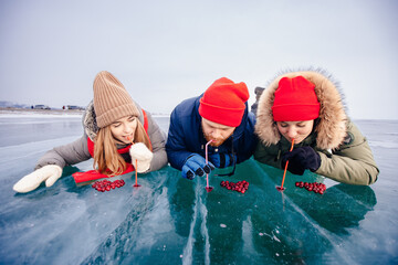 Concept travel Russia. Group tourist drink cocktail winter ice kiss of Lake Baikal with cranberry heart